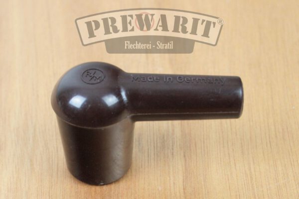 Seitliche Ansicht eines unpolierten Kerzenstecker aus braunem Bakelit im Patina Look, der nicht entstört ist.