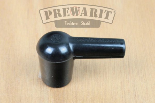 Seitliche Ansicht eines unpolierten Kerzenstecker aus schwarzem Bakelit im Patina Look, der nicht entstört ist.